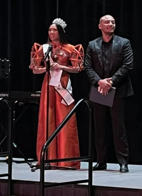 A performer in a red gown on stage