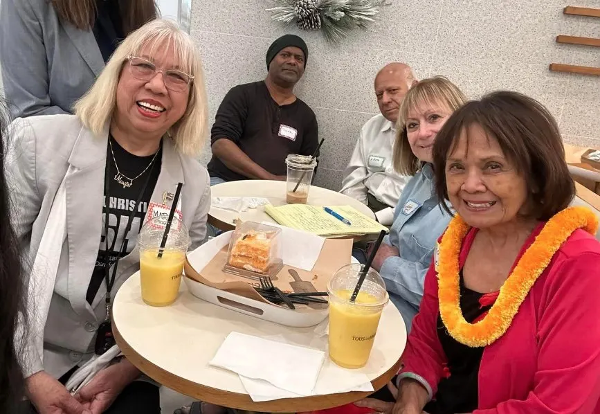 Friends sharing drinks at a community gathering